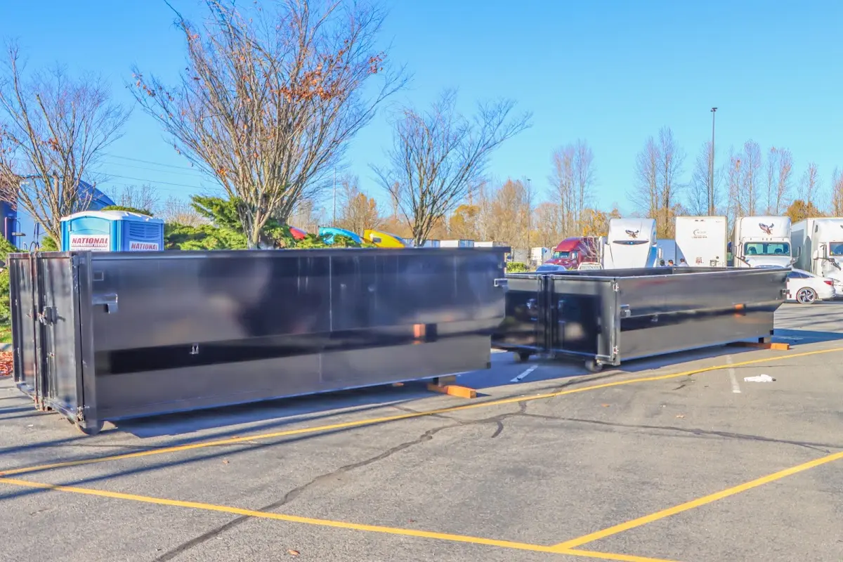 Professional dumpster rental service with roll-off container on residential driveway in Saline